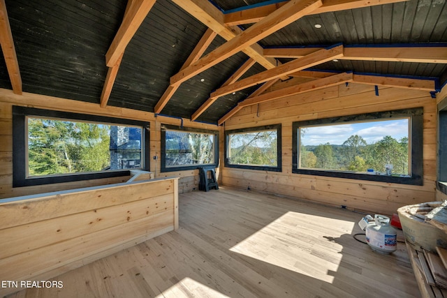 unfurnished sunroom featuring wooden ceiling and vaulted ceiling with beams