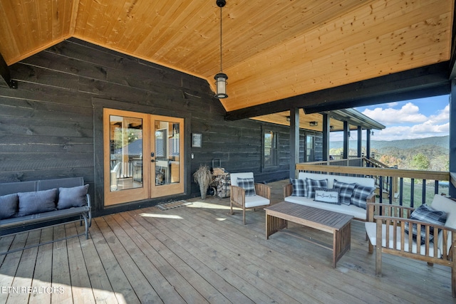 wooden deck featuring an outdoor hangout area and a mountain view