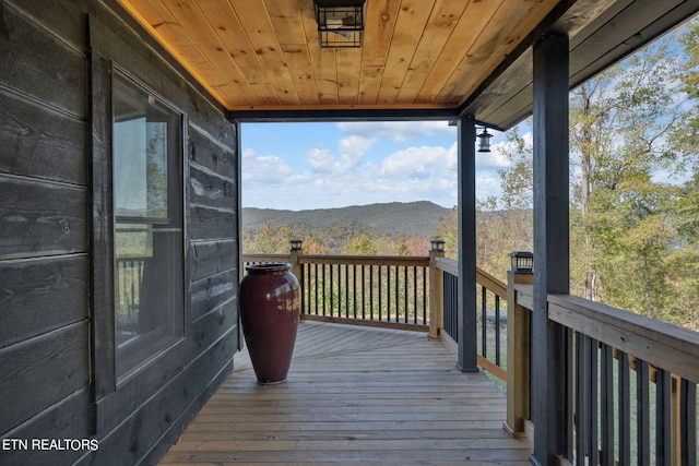 wooden deck with a mountain view