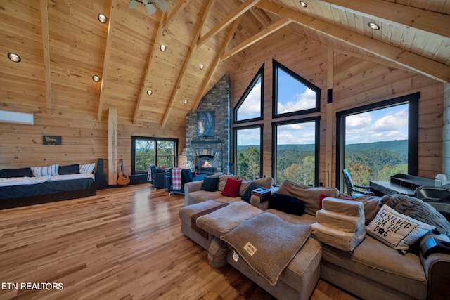 living room featuring hardwood / wood-style flooring, high vaulted ceiling, and wood ceiling