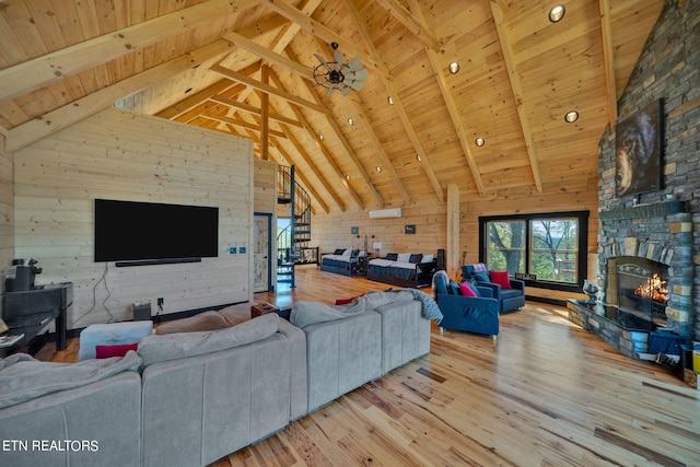 living room featuring beamed ceiling, hardwood / wood-style floors, and wood ceiling