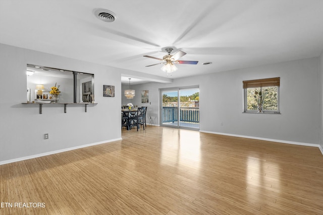 unfurnished living room with ceiling fan and hardwood / wood-style flooring