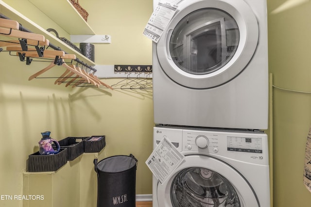 laundry area with stacked washing maching and dryer