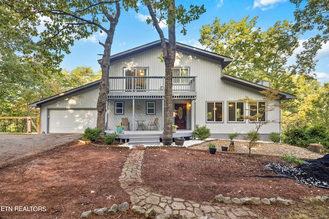 modern inspired farmhouse with a balcony and a garage