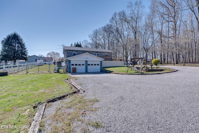 1506 W Cunningham Rd, Seymour, TN 37865 - exterior space featuring an outbuilding, fence, a yard, gravel driveway, and a detached garage