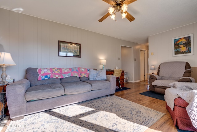 living room with ceiling fan and hardwood / wood-style floors