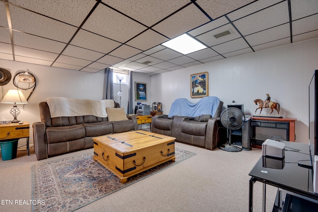 living room with a paneled ceiling and carpet flooring