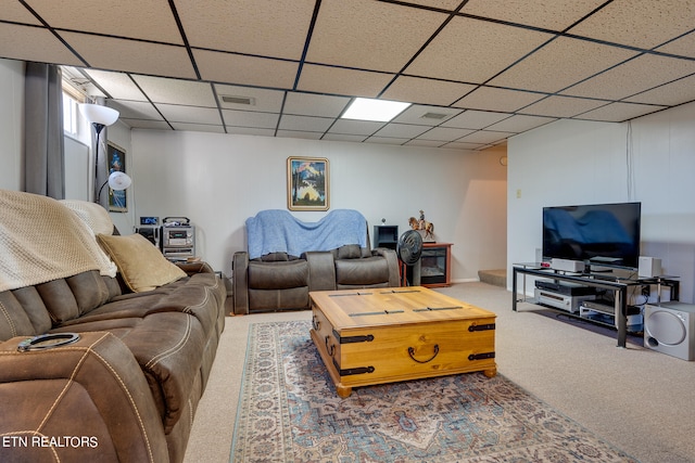 carpeted living room with a drop ceiling