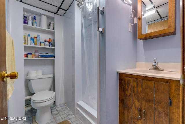 bathroom featuring vanity, a paneled ceiling, tile patterned floors, walk in shower, and toilet