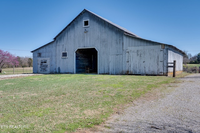 view of outbuilding with a lawn