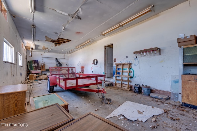 misc room with a workshop area and concrete flooring