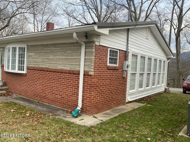 view of side of property with a lawn