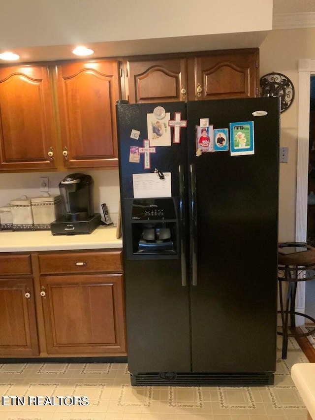 kitchen featuring black fridge with ice dispenser