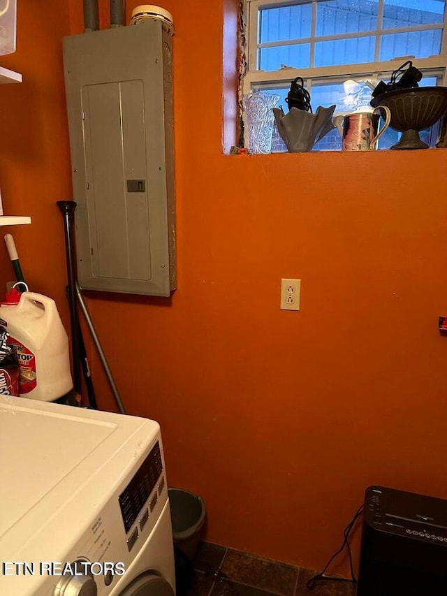 laundry area featuring electric panel, washer / dryer, and tile patterned floors