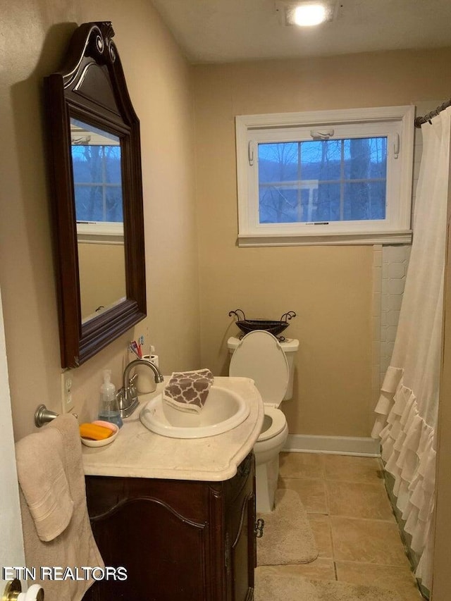 bathroom featuring tile patterned floors, toilet, vanity, and a shower with shower curtain