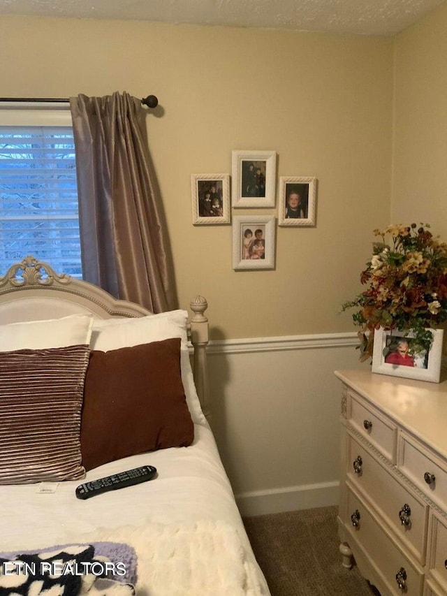 carpeted bedroom featuring a textured ceiling