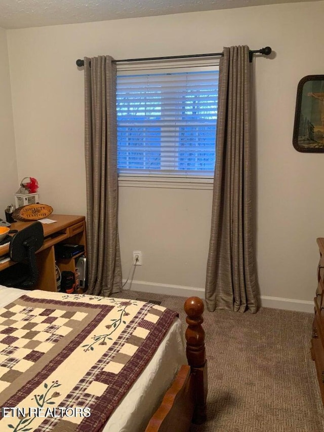 bedroom featuring dark carpet