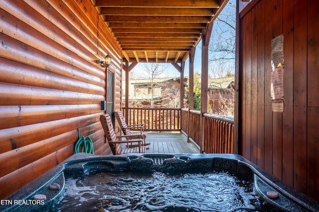 wooden deck with a hot tub