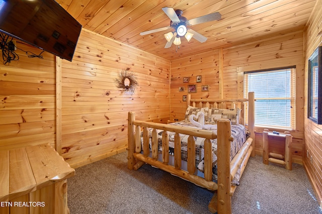 carpeted bedroom with wood walls, wood ceiling, and ceiling fan