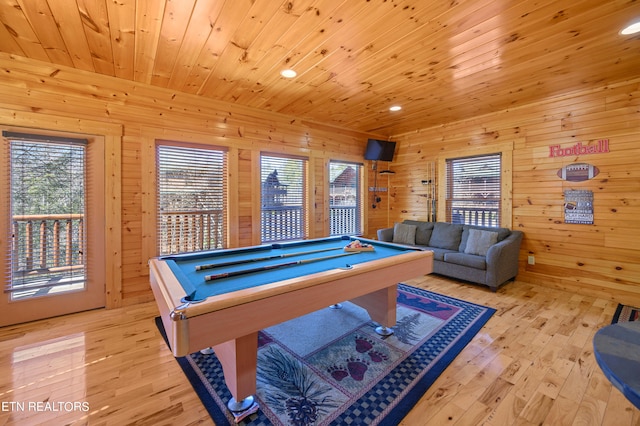 game room with light hardwood / wood-style floors, wood ceiling, billiards, and wooden walls