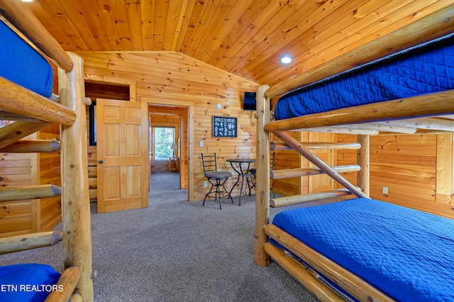 unfurnished bedroom with lofted ceiling, wood walls, dark colored carpet, and wood ceiling