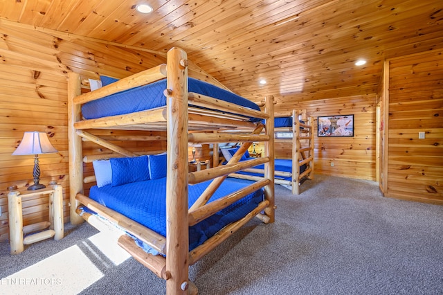 bedroom with carpet flooring, wooden walls, wood ceiling, and vaulted ceiling