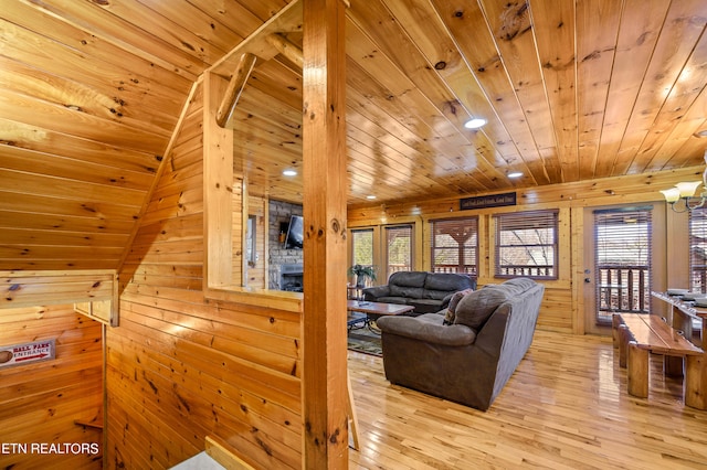 living room with wooden ceiling, wooden walls, and light wood-type flooring