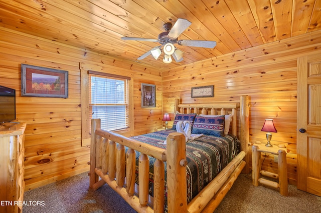 bedroom with carpet, wooden walls, and ceiling fan