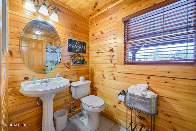 bathroom featuring wooden walls, toilet, wooden ceiling, and tile patterned floors