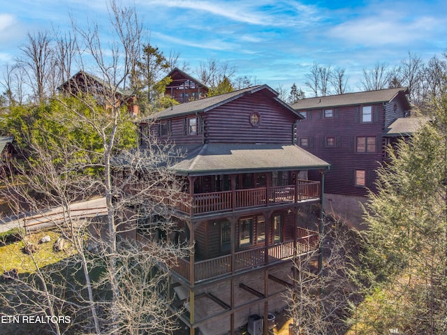 back of property featuring cooling unit and a balcony