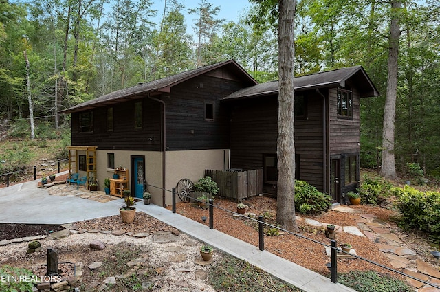 view of side of property featuring a patio area