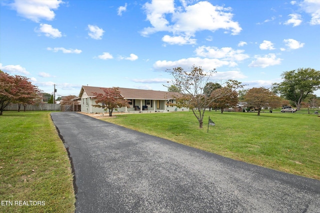 ranch-style house with covered porch and a front lawn