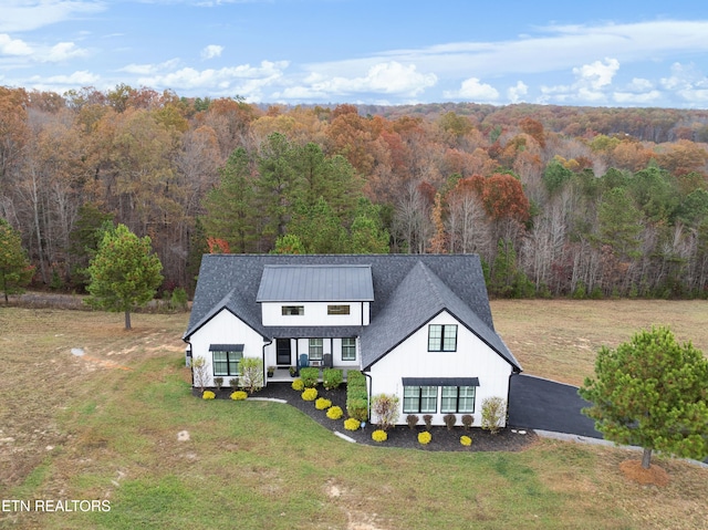 view of front of home featuring covered porch and a front lawn