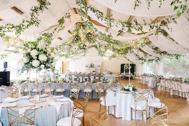 dining space featuring a towering ceiling