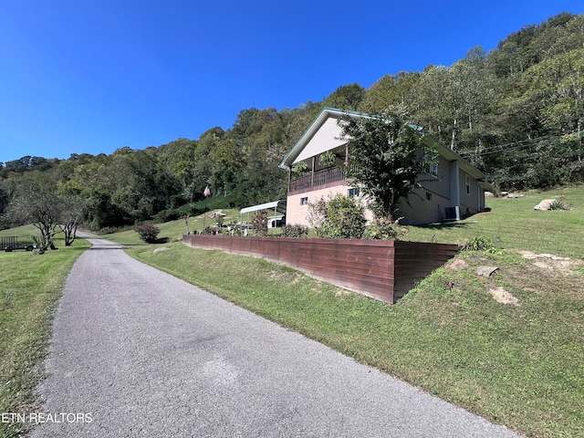 view of side of home with a lawn