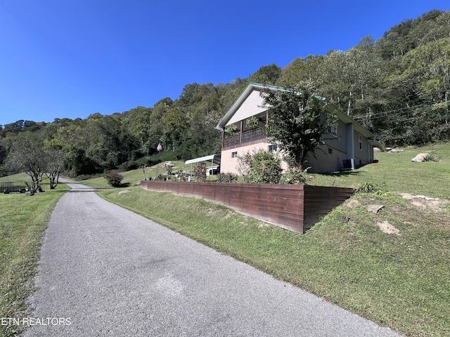 59 River Rd, Miracle, KY 40856 - view of home's exterior featuring a lawn and a wooded view