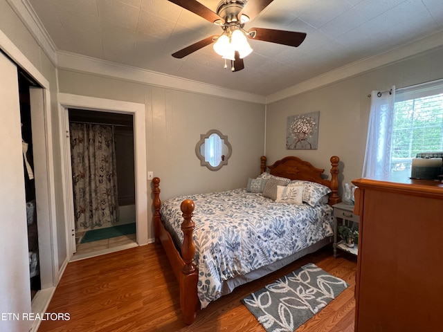 bedroom featuring hardwood / wood-style floors, ceiling fan, ornamental molding, and a closet