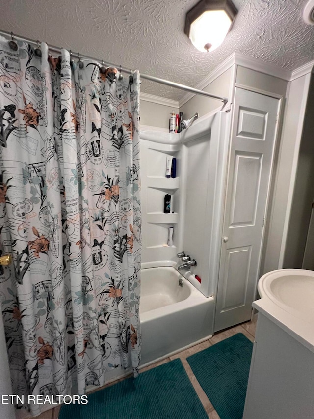 bathroom featuring tile patterned flooring, shower / bath combo, a textured ceiling, and vanity