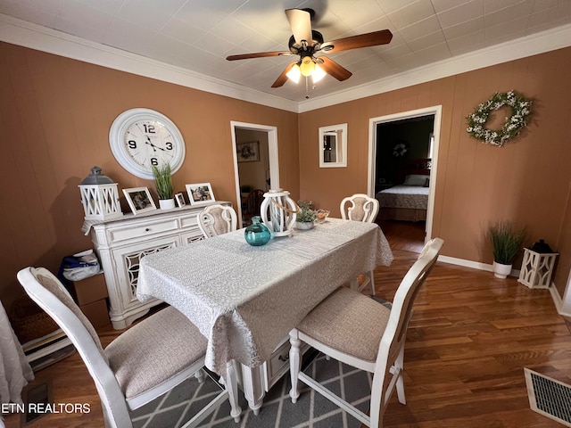 dining space featuring ceiling fan, dark hardwood / wood-style flooring, and ornamental molding