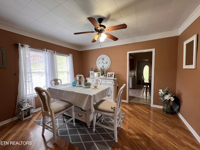 dining area featuring crown molding, dark hardwood / wood-style flooring, and ceiling fan