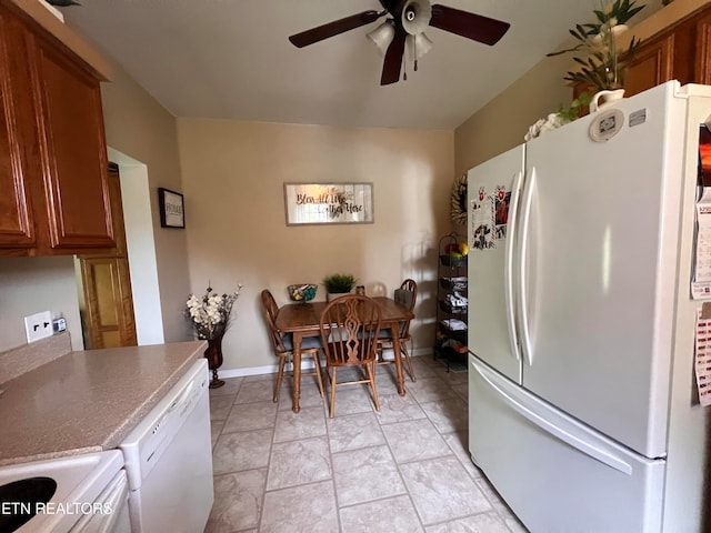 kitchen with ceiling fan, white appliances, and light tile patterned floors