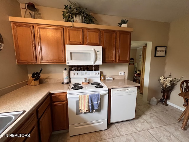 59 River Rd, Miracle, KY 40856 - kitchen with white appliances, brown cabinetry, light countertops, and light tile patterned floors