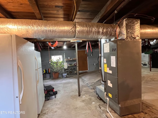 basement with white refrigerator, heating unit, and wooden ceiling