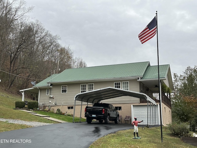 59 River Rd, Miracle, KY 40856 - view of front of home featuring driveway, a front lawn, a metal roof, a detached carport, and a garage