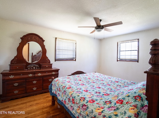 bedroom featuring a textured ceiling, hardwood / wood-style flooring, and ceiling fan