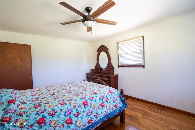 bedroom featuring hardwood / wood-style floors and ceiling fan