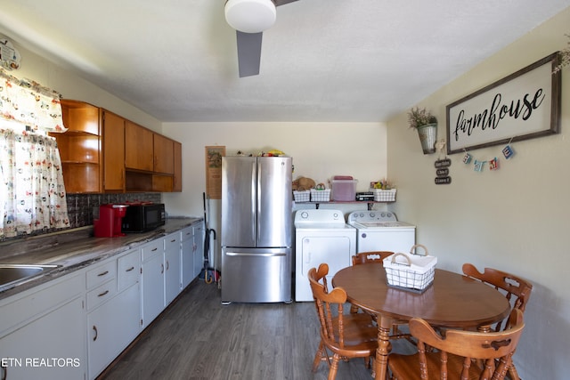 kitchen featuring stainless steel fridge, tasteful backsplash, white cabinetry, dark hardwood / wood-style floors, and washing machine and dryer