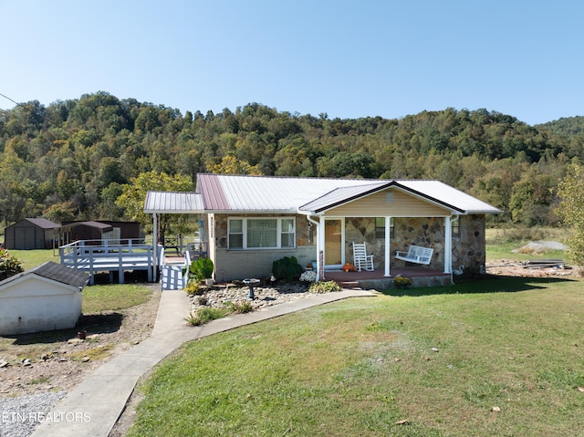 view of front facade with a front yard and a storage shed