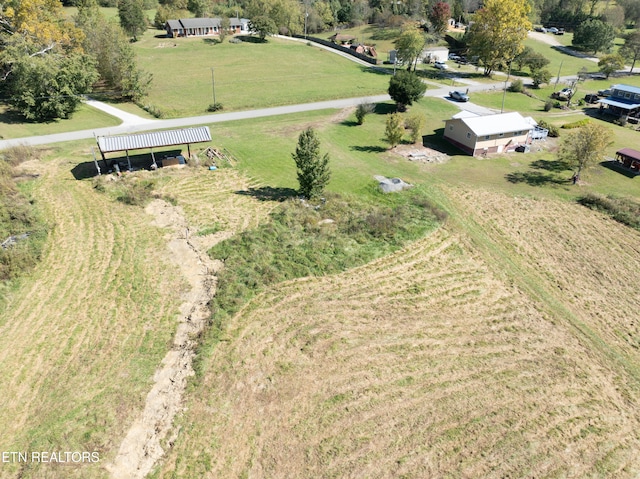 birds eye view of property with a rural view