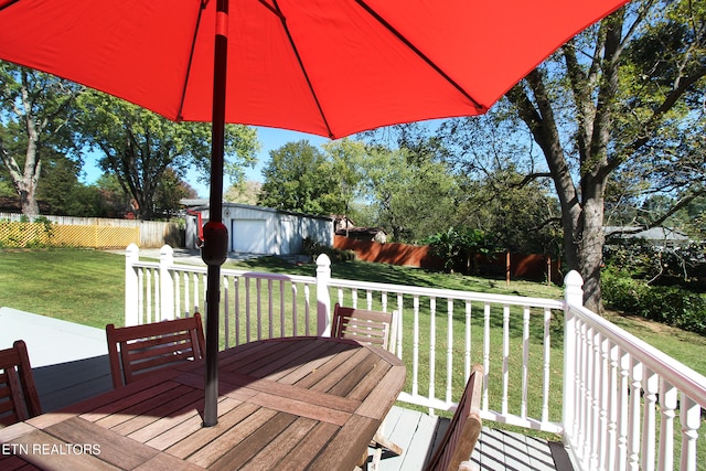 wooden deck with a lawn and a shed